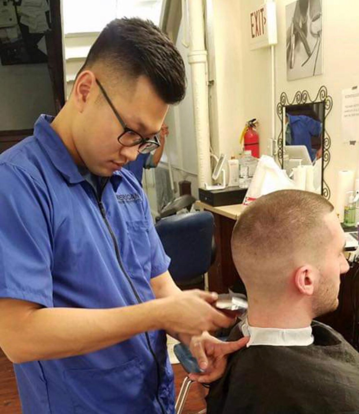 Student fading client's neckline carefully