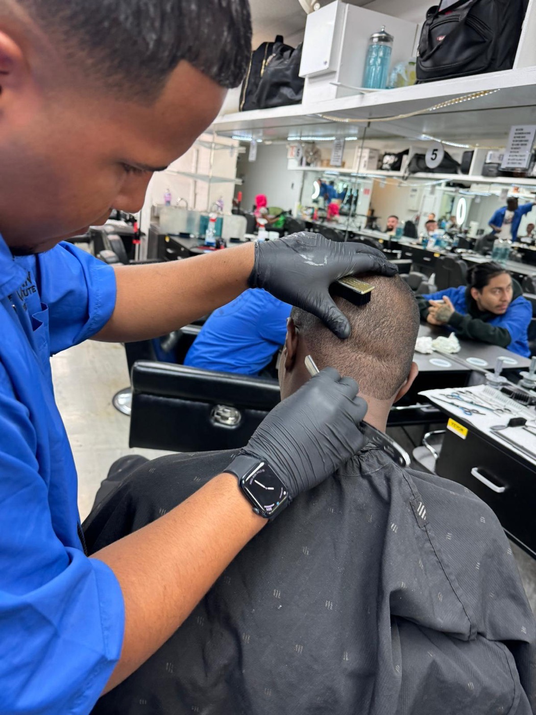 Client in the chair at the ABI barber clinic