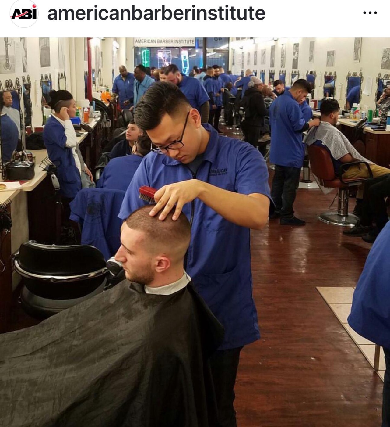 Student combs and cuts client's hair