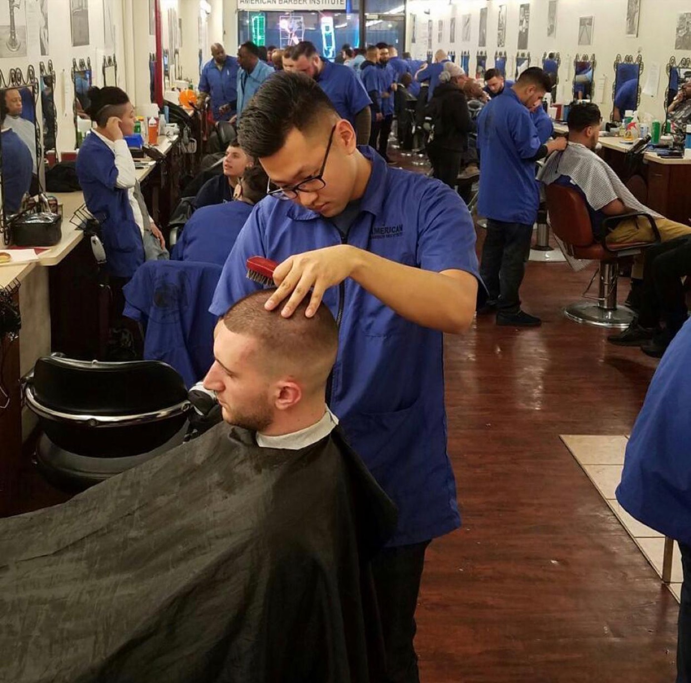 Student cutting client in full classroom