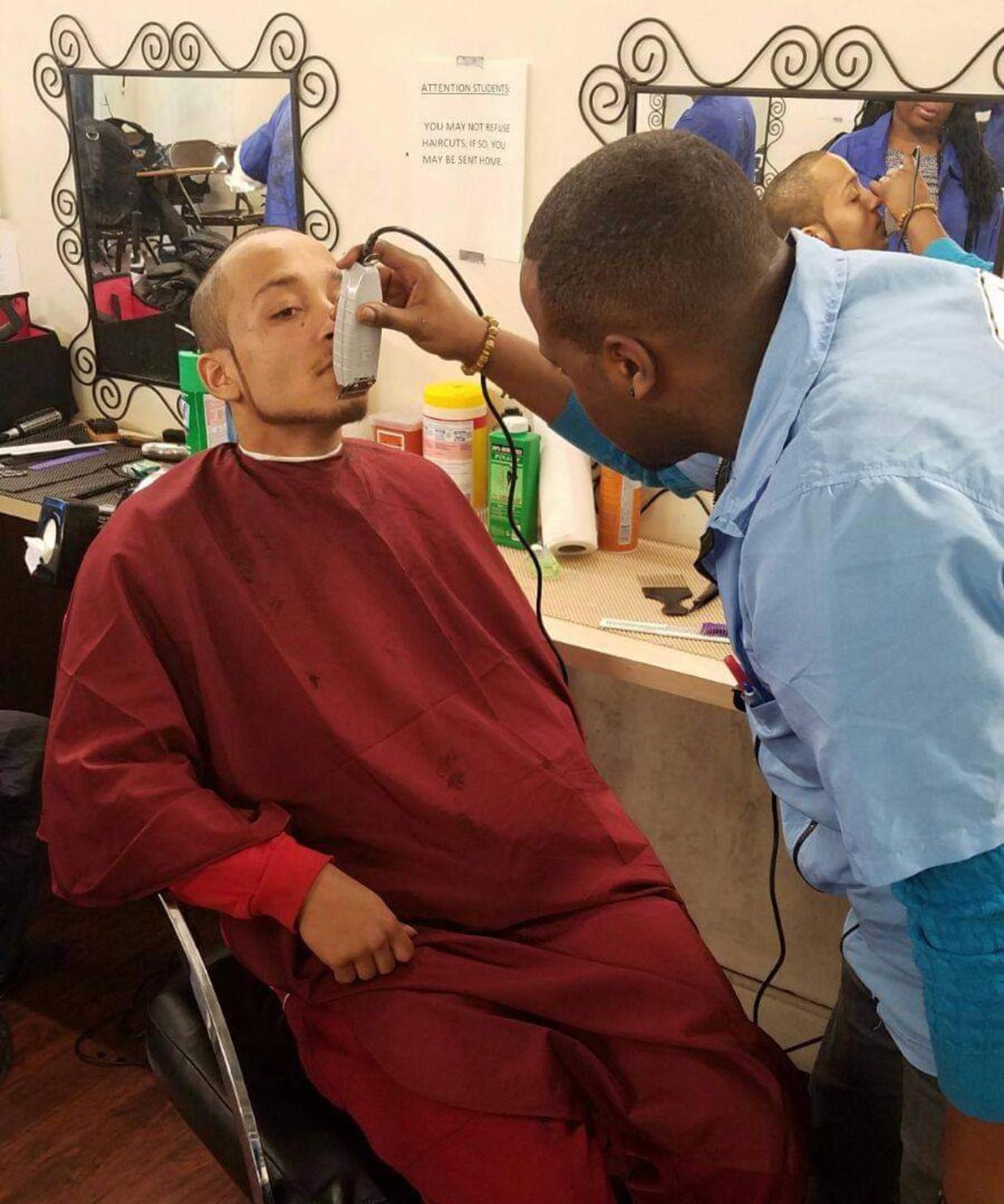 Barber clipping hair in progress