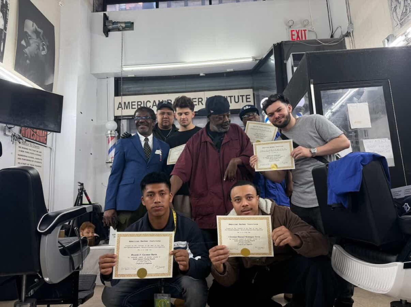 Graduates pose with certificates